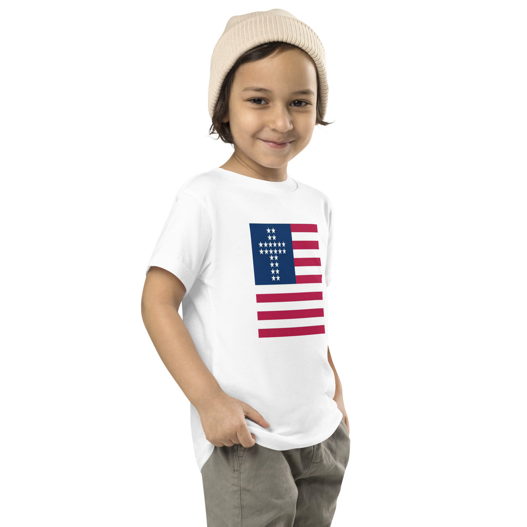 Camiseta con rayas y cruz para niño pequeño